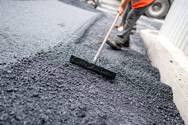 Asphalt being layed by worker